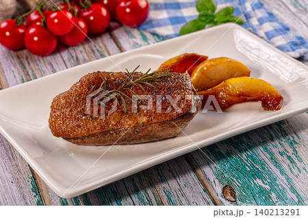 Roasted duck breast with caramelized pears and rosemary on white plate Roasted duck breast with caramelized pears and rosemary on white plate 140213291