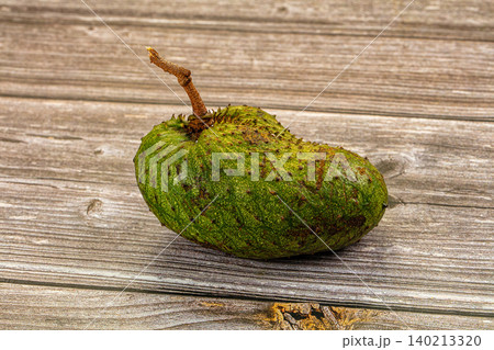 Fresh green soursop fruit isolated on rustic wooden surface 140213320