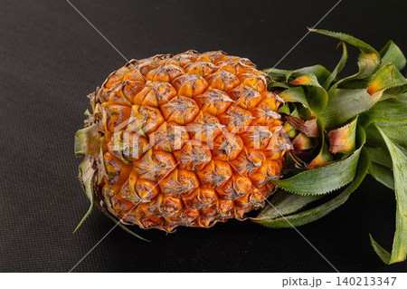 Fresh whole tropical pineapple on black background Fresh whole tropical pineapple on black background 140213347