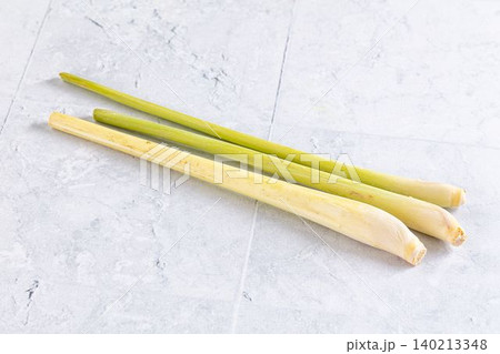 Fresh lemongrass stalks on light gray stone background Fresh lemongrass stalks on light gray stone background 140213348