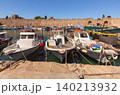 Fishing boats moored in Rhodes harbor near medieval walls on sunny clear summer day 140213932