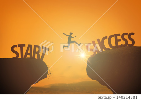 Male person jumps across a gap between start and success against gold sunset sky, sun Male person jumps across a gap between start and success against gold sunset sky, sun 140214581