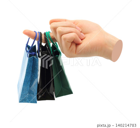 Hand holds mini shopping bag, isolated on transparent background, shopping concept. Contemporary art design Hand holds mini shopping bag, isolated on transparent background, shopping concept. Contemporary art design 140214783