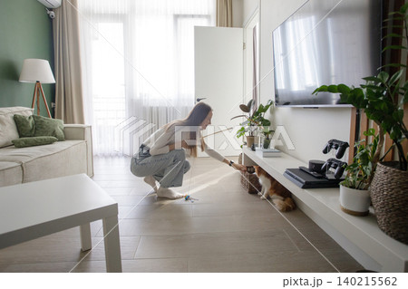 Young woman with cat playing and having fun at home Young woman with cat playing and having fun at home 140215562