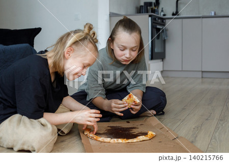 Healthy kids sibling eating pizza at home. Little girl and boy children portrait Healthy kids sibling eating pizza at home. Little girl and boy children portrait 140215766