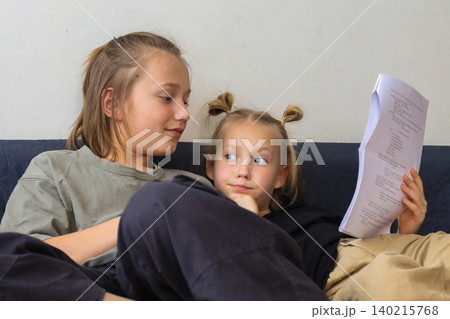 Cute sibling learning a role for the school drama club at home Cute sibling learning a role for the school drama club at home 140215768