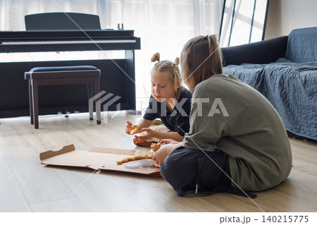 Pretty kids sibling eating pizza at home. Little girl and boy children portrait Pretty kids sibling eating pizza at home. Little girl and boy children portrait 140215775