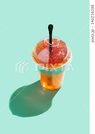Person holding a colorful layered slushie drink Person holding a colorful layered slushie drink 140216286