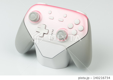Modern game controller on a light background showing design features Modern game controller on a light background showing design features 140216734