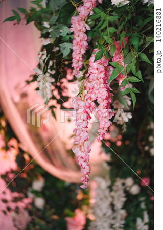 Vertical shot of hanging wedding decoration with pink wisteria and white flowers Vertical shot of hanging wedding decoration with pink wisteria and white flowers 140216881