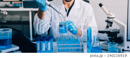 Lab technician experimenting in lab 140216919
