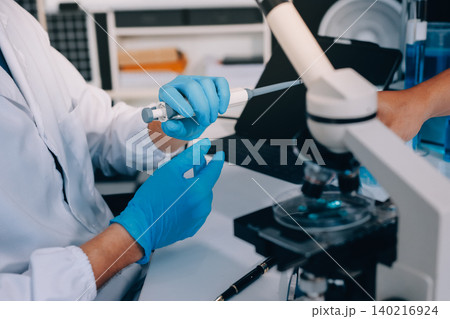 Lab technician experimenting in lab 140216924