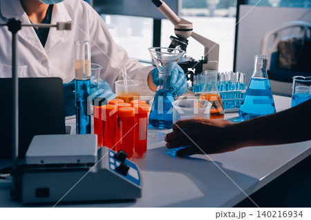 Lab technician experimenting in lab 140216934