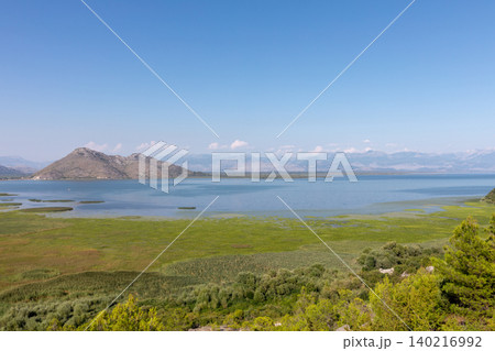 Panoramic view of Lake Skadar wetlands and mountains on a clear summer day Panoramic view of Lake Skadar wetlands and mountains on a clear summer day 140216992