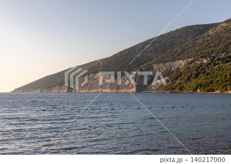 Adriatic Sea coastline with limestone cliffs and forested hills in Montenegro 140217000