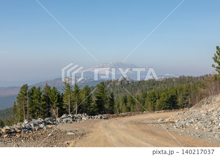 Mountain landscape near Konzhakovsky Stone with forest and dirt road panorama Mountain landscape near Konzhakovsky Stone with forest and dirt road panorama 140217037