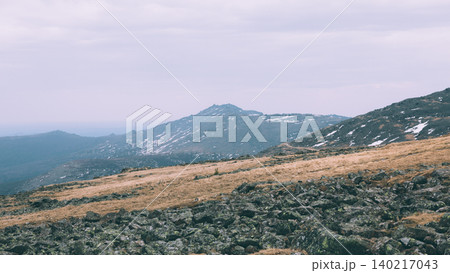 Konzhakovsky Stone mountain tundra landscape with rocks and snow patches, Ural Konzhakovsky Stone mountain tundra landscape with rocks and snow patches, Ural 140217043