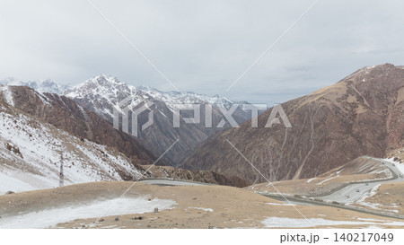 Scenic mountain road at Too Ashuu Pass with snowy peaks, Kyrgyzstan panorama Scenic mountain road at Too Ashuu Pass with snowy peaks, Kyrgyzstan panorama 140217049