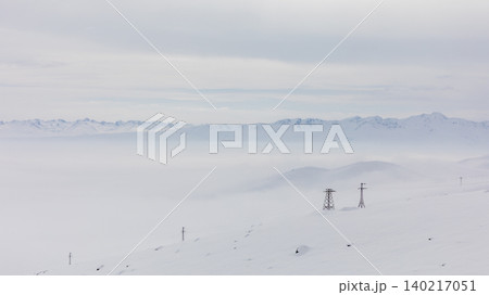 Ala-Bel Pass winter landscape with fog and power lines in Kyrgyzstan mountains Ala-Bel Pass winter landscape with fog and power lines in Kyrgyzstan mountains 140217051