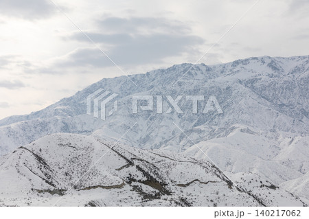 Snowy mountains near Toktogul with winter clouds over Kyrgyz landscape Snowy mountains near Toktogul with winter clouds over Kyrgyz landscape 140217062