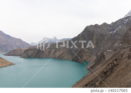 Turquoise river in Naryn Canyon with rugged mountains and cloudy sky, Kyrgyzstan Turquoise river in Naryn Canyon with rugged mountains and cloudy sky, Kyrgyzstan 140217065