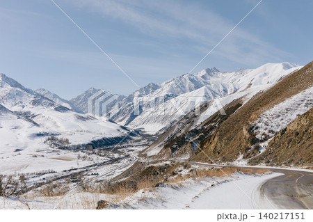 Scenic mountain road through snowy Tien Shan valley landscape in Kyrgyzstan 140217151