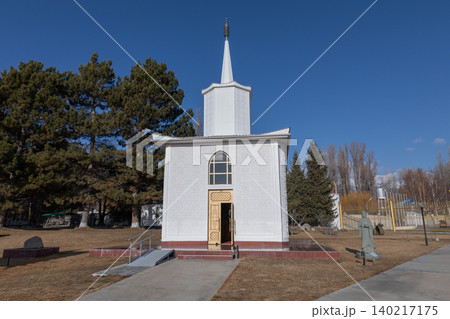 White chapel building at Rukh Ordo cultural complex in Cholpon-Ata park, Kyrgyzstan 140217175