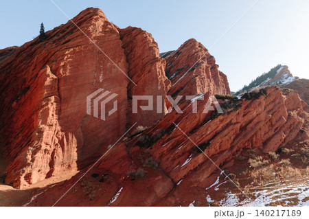 Seven Bulls red sandstone cliffs and winter snow in Jeti Oguz canyon landscape Seven Bulls red sandstone cliffs and winter snow in Jeti Oguz canyon landscape 140217189