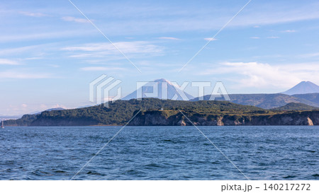 Volcanic coastline and sea view with distant volcanoes in Kamchatka Peninsula Volcanic coastline and sea view with distant volcanoes in Kamchatka Peninsula 140217272
