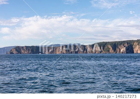 Rocky sea cliffs and calm ocean horizon on Kamchatka Peninsula coastline, Russia 140217273
