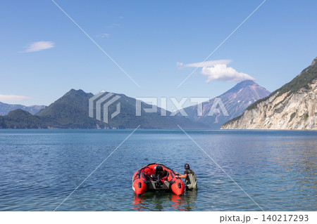 Vilyuchinskaya Bay seascape with volcano and inflatable boat, Kamchatka 140217293