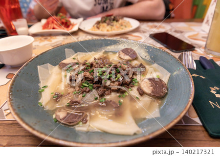 Traditional beshbarmak with horse meat and noodles served in a restaurant 140217321
