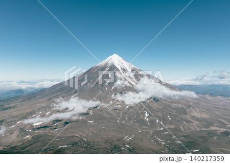 Aerial view of Koryaksky Volcano with snow summit and clouds, Kamchatka 140217359