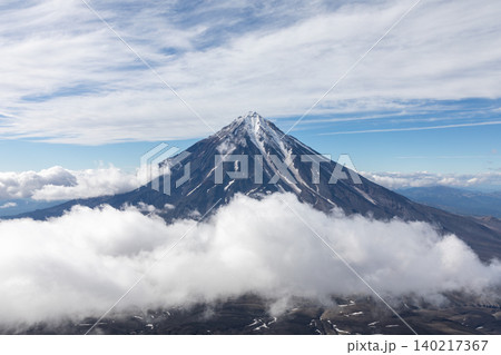 Koryaksky volcano peak above clouds under blue sky, Kamchatka landscape view 140217367
