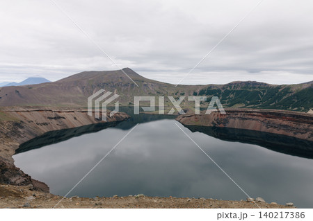 Ksudach volcano caldera lake with crater rim landscape on Kamchatka Peninsula Ksudach volcano caldera lake with crater rim landscape on Kamchatka Peninsula 140217386
