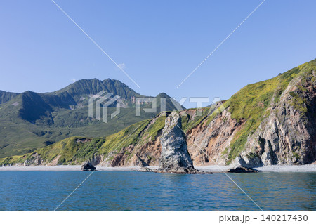 Rugged sea cliffs and volcanic mountains on the Kamchatka Peninsula coastline Rugged sea cliffs and volcanic mountains on the Kamchatka Peninsula coastline 140217430