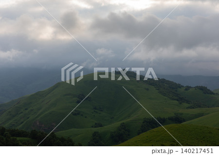 Misty green hills and dramatic storm clouds over Aktoprak mountain valley Misty green hills and dramatic storm clouds over Aktoprak mountain valley 140217451