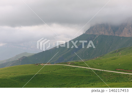 Scenic mountain road and green alpine meadow near Aktoprak pass, Caucasus Scenic mountain road and green alpine meadow near Aktoprak pass, Caucasus 140217453