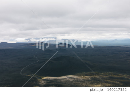 Volcanic landscape of Tolbachinsky Dol lava fields under cloudy sky, Kamchatka Volcanic landscape of Tolbachinsky Dol lava fields under cloudy sky, Kamchatka 140217522