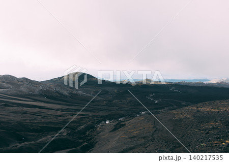 Tolbachinsky Dol volcanic landscape with black lava fields and distant peaks Tolbachinsky Dol volcanic landscape with black lava fields and distant peaks 140217535
