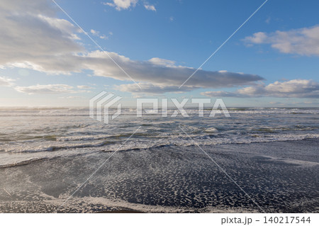 Khalaktyrsky Beach black sand shoreline with waves and blue sky, Kamchatka Khalaktyrsky Beach black sand shoreline with waves and blue sky, Kamchatka 140217544