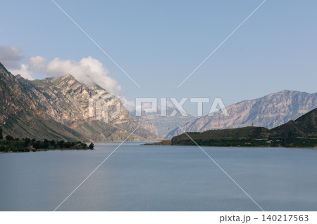 Irganay Reservoir mountain lake landscape with calm water and Caucasus peaks Irganay Reservoir mountain lake landscape with calm water and Caucasus peaks 140217563
