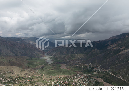 Mountain valley landscape in Dagestan with river and dramatic storm clouds Mountain valley landscape in Dagestan with river and dramatic storm clouds 140217584