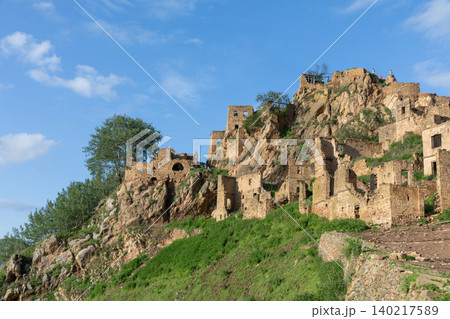 Ruins of abandoned mountain village of Gamsutl on rocky slope in Dagestan Ruins of abandoned mountain village of Gamsutl on rocky slope in Dagestan 140217589