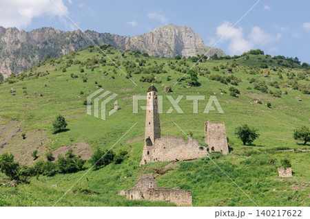 Egikal tower complex ruins on green mountain slope in the Caucasus landscape Egikal tower complex ruins on green mountain slope in the Caucasus landscape 140217622