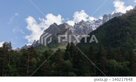 Mountain landscape with forest and snowy peaks in Ingushetia, Caucasus region Mountain landscape with forest and snowy peaks in Ingushetia, Caucasus region 140217648