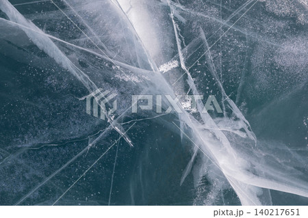 Abstract cracked ice texture on Lake Baikal surface, winter natural background Abstract cracked ice texture on Lake Baikal surface, winter natural background 140217651