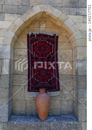 Traditional rug and clay amphora in stone arch niche at Naryn-Kala fortress, Derbent 140217701