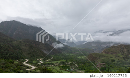 Misty mountain valley with winding road in Dagestan, Caucasus landscape view Misty mountain valley with winding road in Dagestan, Caucasus landscape view 140217726