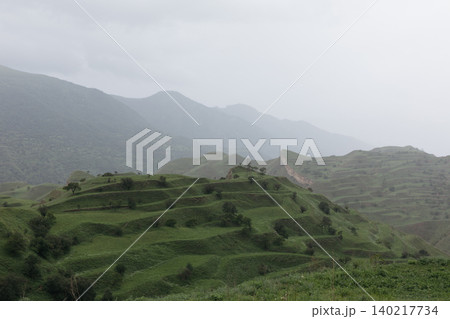 Misty spring view of Chokh Terraces green hills in the Caucasus Mountains Misty spring view of Chokh Terraces green hills in the Caucasus Mountains 140217734